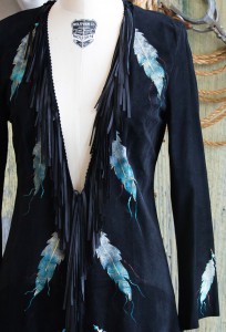 leather jack with fringe and feather detail close up